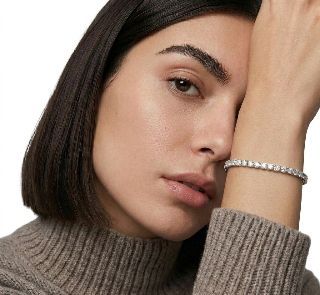 Woman wearing a brown turtleneck sweater with a close-up of her face and hand.