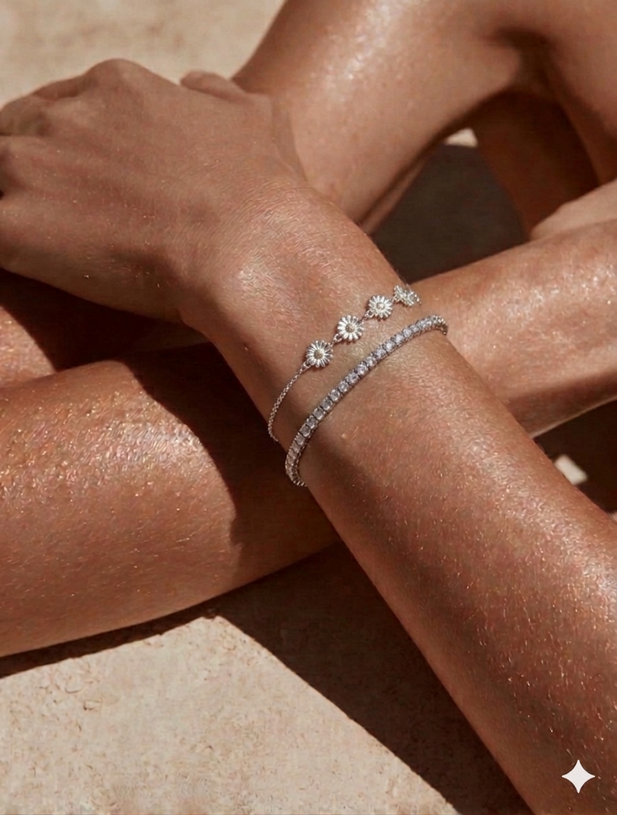 Close-up of a wrist wearing multiple diamond bracelets on a neutral background