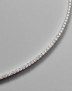 2mm lab stone tennis bracelet catching golden hour light on woman's wrist